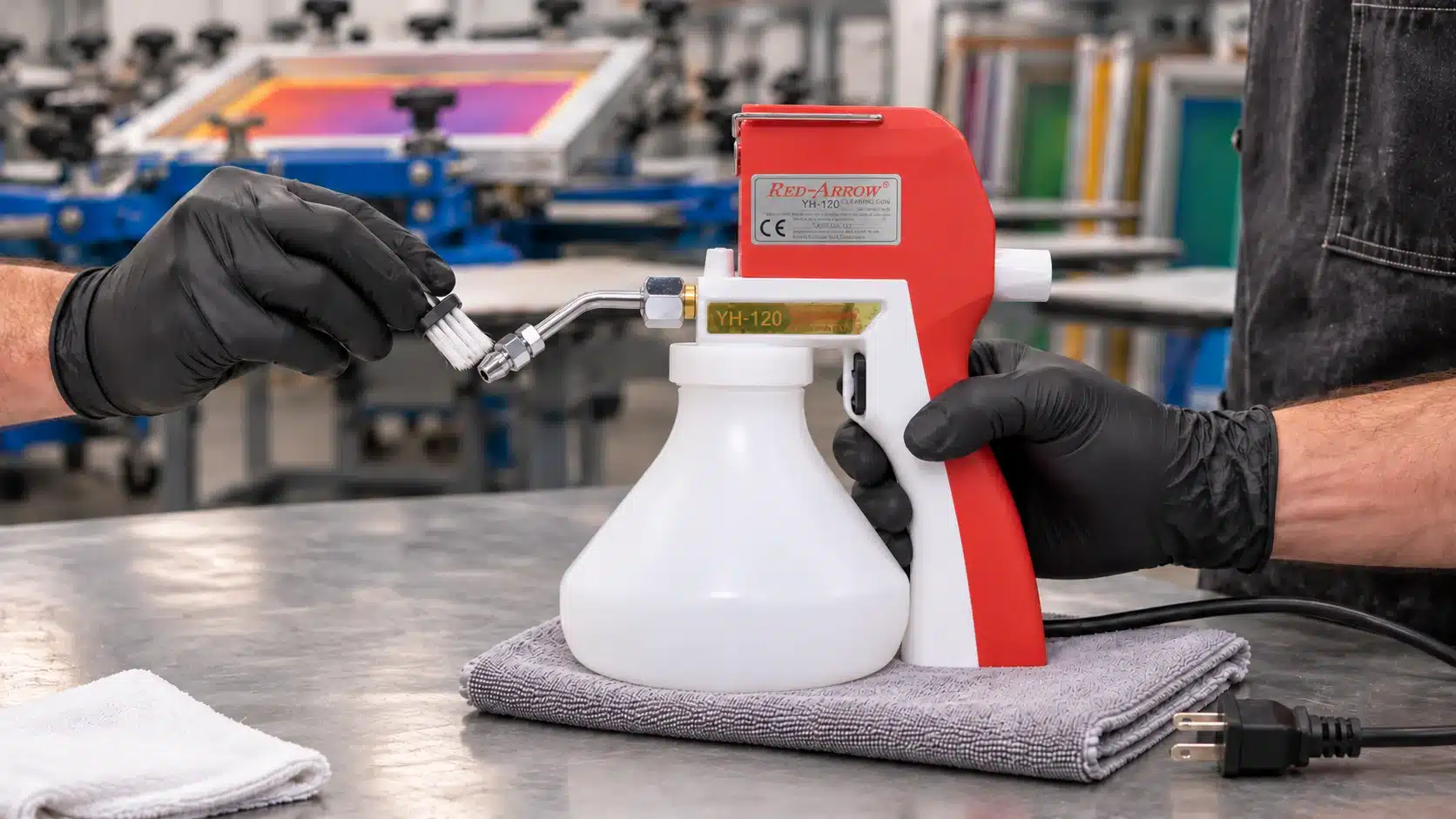Workshop cleaning a red and white airbrush